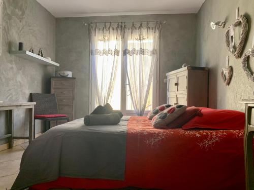 a bedroom with a large bed and a window at Villa fiora chambre in Martigues