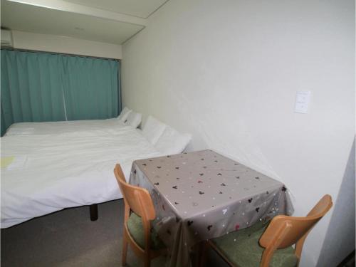 a room with a bed and a table and chairs at T-Port - Vacation STAY 12338 in Toyama