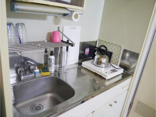 a kitchen with a stainless steel sink and a stove at T-Port - Vacation STAY 12338 in Toyama