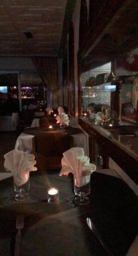 a dining room with a table with a candle and a table sidx sidx sidx at Hotel Tachfine in Marrakech