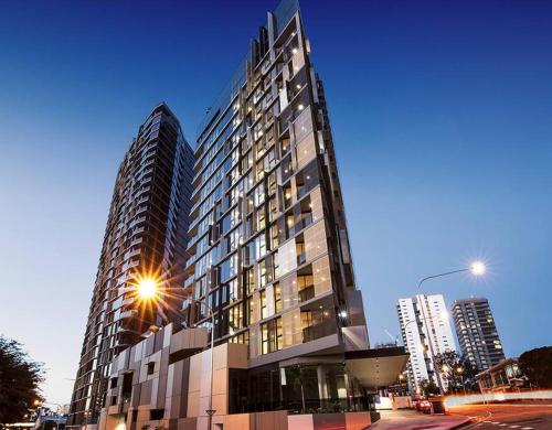 a tall building with a street light in front of it at Southbank Apartment with pool Brisbane CBD Hosted by Homestayz in Brisbane