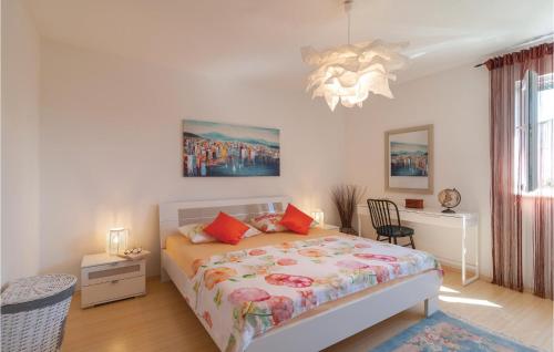 a bedroom with a bed and a chandelier at Amazing Home In Split With Wifi in Split