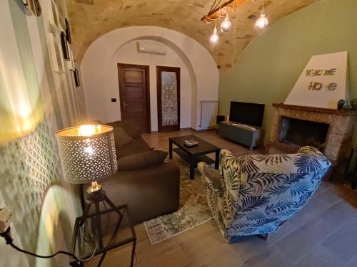 een woonkamer met een bank en een open haard bij Casa Laura in Corfinio