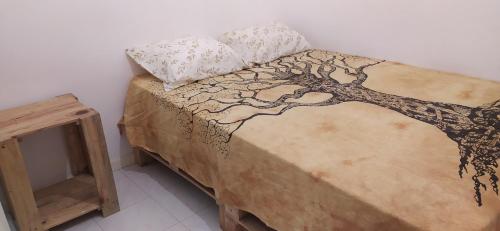 a bed with a tree design on top of it at Samara's Home in Mindelo