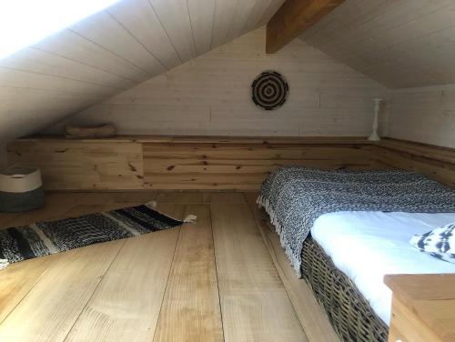 an attic bedroom with two beds and a wooden floor at la Varangue in Lacanau