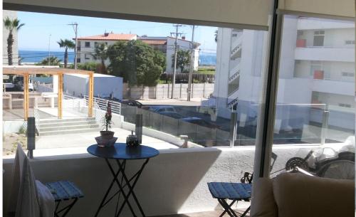 a balcony with a table and a view of the ocean at Departamento La Serena in La Serena