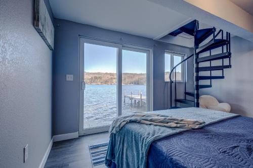 a bedroom with a bed and a view of the water at Modern Winnipesaukee Lake Front Retreat Siena in Alton