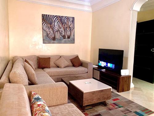 a living room with a couch and a tv at Sab 1 - Superb View - Comfy and well located in Casablanca