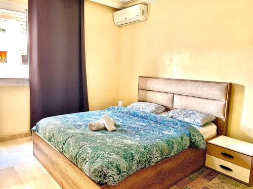 a bedroom with a bed with a stuffed animal on it at Sab 1 - Superb View - Comfy and well located in Casablanca