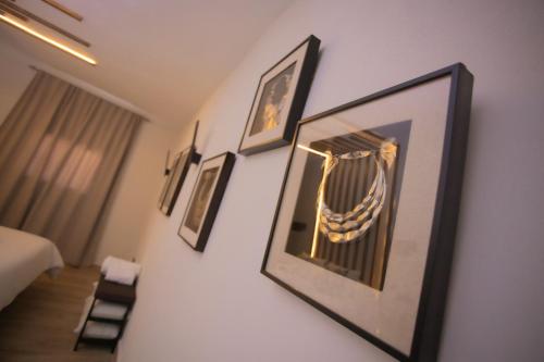 a room with framed pictures on a wall at Azahara Casa Boutique in Arcos de la Frontera