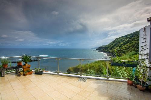 a balcony with a view of the ocean at Maré Alta - Casa de Férias in Maia