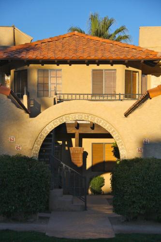a house with an archway in front of it at The Oasis Resort in Palm Springs