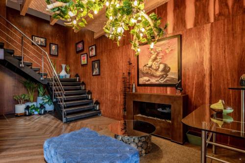 a living room with a fireplace and a staircase at Sonesta Hotel Bogotá in Bogotá