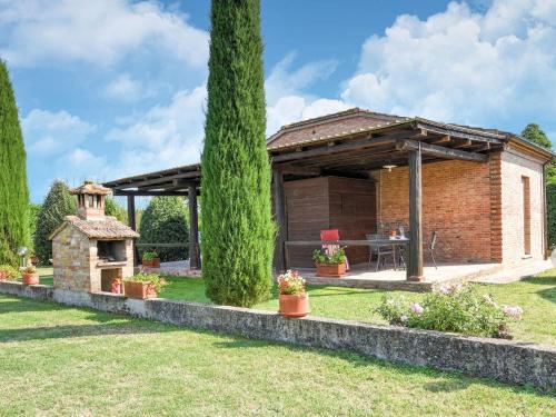 a brick house with a wooden roof and a grill at Belvilla by OYO Chiaraquattro in Acquaviva