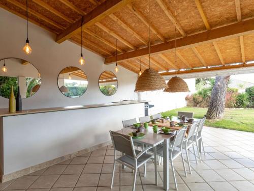 an outdoor dining area with a table and chairs at Magnificent villa with private pool in Narbonne