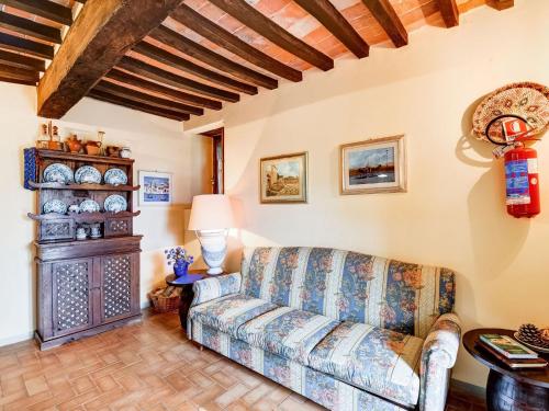 a living room with a couch and a fireplace at Belvilla by OYO Welcoming Holiday Home with Pool in Monterchi