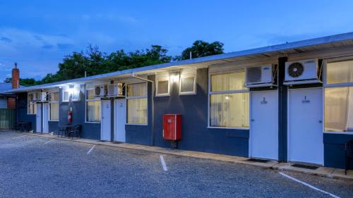 a blue building with windows and machines on it at Sun Centre Motel in Swan Hill