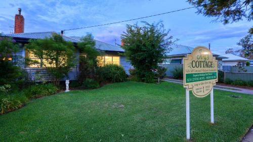 a sign in a yard in front of a house at Sun Centre Motel in Swan Hill