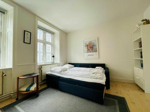 a bedroom with a bed and a book shelf at ApartmentInCopenhagen Apartment 200 in Copenhagen