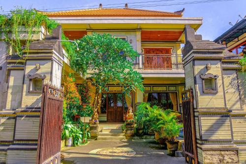 a house with a gate in front of it at Adi Homestay in Canggu