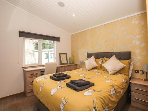a bedroom with a bed with two towels on it at Ridgway Lodge in Windermere