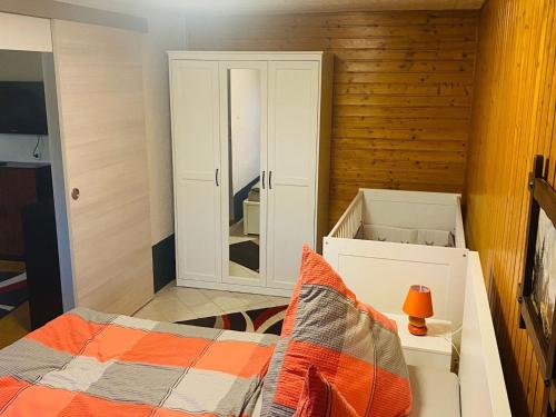 a small bedroom with a bed and a mirror at Peaceful Forest Getaway in Altenfeld