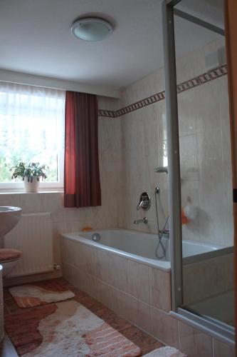 a bathroom with a bath tub and a window at sonnberg in Ischgl