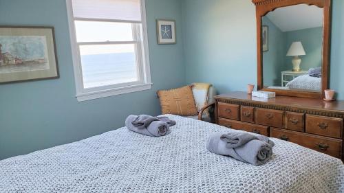 a bedroom with a bed with towels on it at Oceanfront Penthouse with Family & Friends in Salisbury