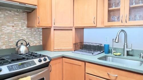 a kitchen with a stove and a sink at Oceanfront Penthouse with Family & Friends in Salisbury