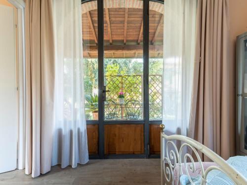 a bedroom with a window and a bed with curtains at Blissful Tuscan Hideaway in Arezzo