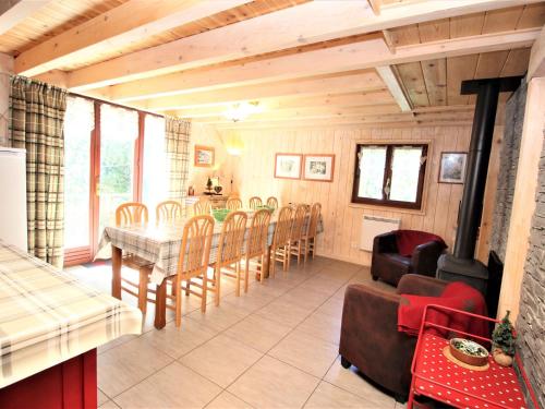 a dining room with a table and chairs at Nice sea view apartment with pool in Valfréjus