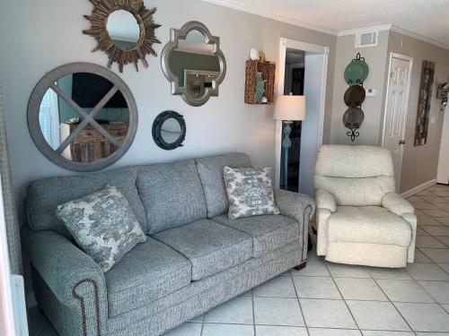 a living room with a couch and a chair at Bill’s at Gulf Shores in Gulf Shores