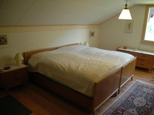 a bedroom with a large bed and a window at Chalet in M rel with Terrace Parking Garden Furniture in Mörel