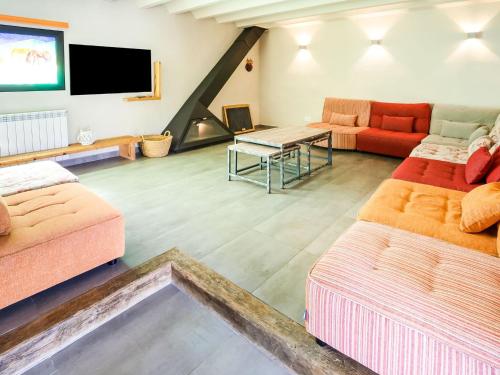 a living room with two couches and a tv at Belvilla by OYO Belians in Vallcebre