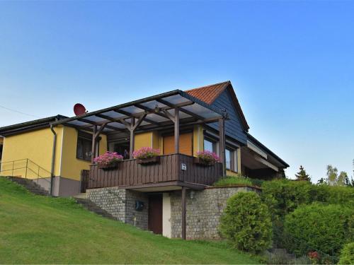 GüntersbergeにあるCozy Holiday Home in G ntersberge with Lake Viewの黄色の家 バルコニー付