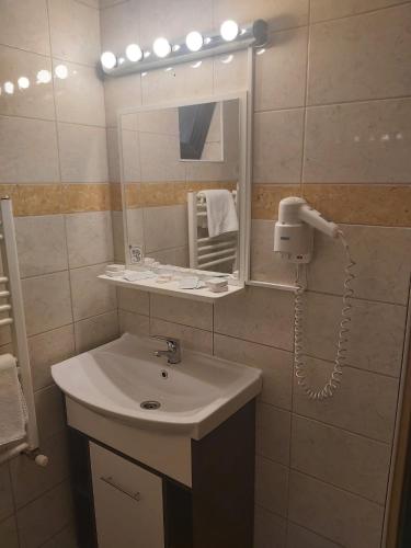 a bathroom with a sink and a mirror at Traveland Boutique Resort Poiana Brasov in Poiana Brasov