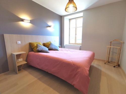een slaapkamer met een roze bed en een raam bij Gîte Vielprat, 1 pièce, 4 personnes - FR-1-582-337 in Vielprat