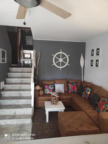 a living room with a couch and a steering wheel on the wall at Casa completa SAME Casa Blanca in Same