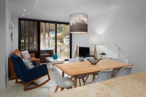 a living room with a dining room table and chairs at St Falls Resort in Falls Creek