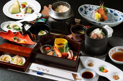 a table with plates of food and bowls of food at Tokachigawa Onsen Daiichi Hotel in Otofuke