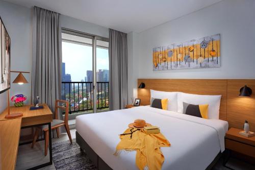 Postel nebo postele na pokoji v ubytování Citadines Sudirman Jakarta