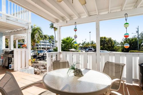 a patio with a table and chairs and a street at Kawama Yacht Club A4 in Key Largo