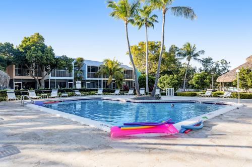 a swimming pool with two inflatables in a resort at Kawama Yacht Club A4 in Key Largo