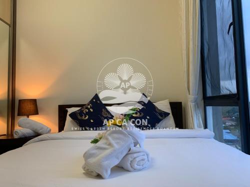 a hotel room with a bed with a towel on it at SG Resort Residences Kuantan by AP CA CON in Kampung Sungai Karang