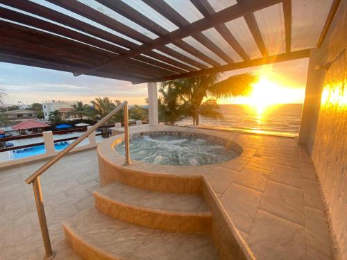 a hot tub on a patio with a sunset at Palmazul Hotel & Spa in San Clemente