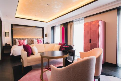 a hotel room with a couch and a bed at Fauchon Hotel Kyoto in Kyoto
