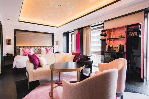 a living room with a couch and a bed at Fauchon Hotel Kyoto in Kyoto