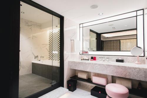 a bathroom with a sink and a mirror at Fauchon Hotel Kyoto in Kyoto