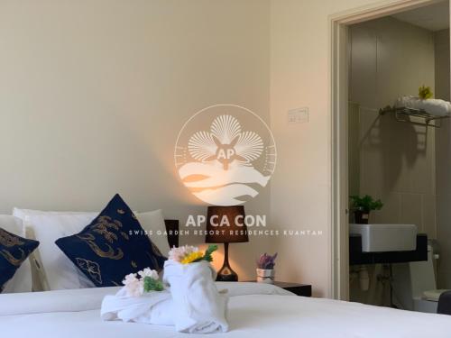 a bedroom with a bed with towels on it at SG Resort Residences Kuantan by AP CA CON in Kampung Sungai Karang