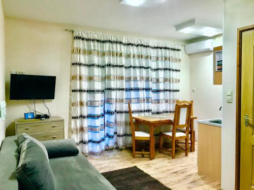 a living room with a couch and a table at Barki Apartman in Bük